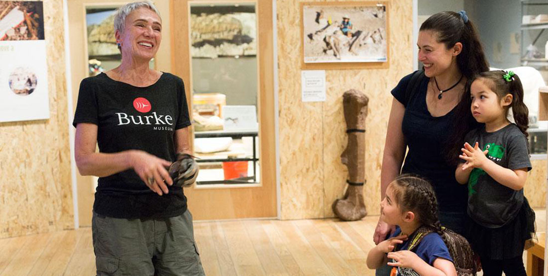 a woman laughs with a mom and her two daughters